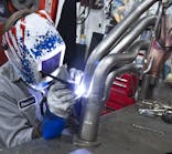 When welding, wear an approved welding helmet with auto- darkening lens, welding gloves and shirt sleeves fully extended.