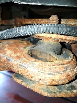 Worn or torn control arm bushings like this one can often cause issues with vehicle handling and possibly tire wear, these need to be checked and repaired before an alignment can be performed.