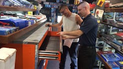 Cornwell Tools dealer Sean Ostler (pictured in foreground) and a customer check out one of the toolboxes on Ostler's truck. 